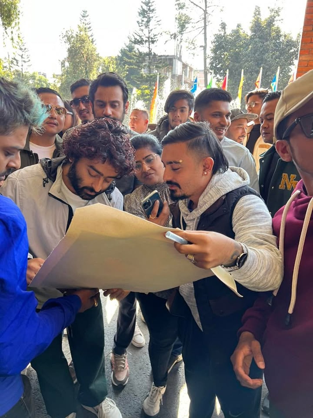 Crew gathered around the running order on site, Kathmandu
